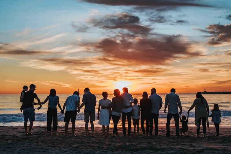 A big family silhouetted against a burning sunset